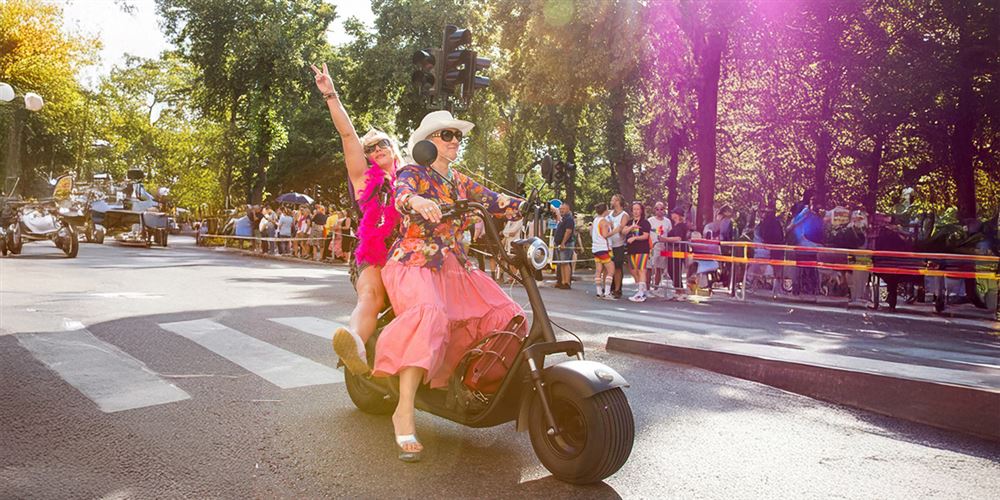 Two woman riding a scooter who wants to start a business in Sweden.